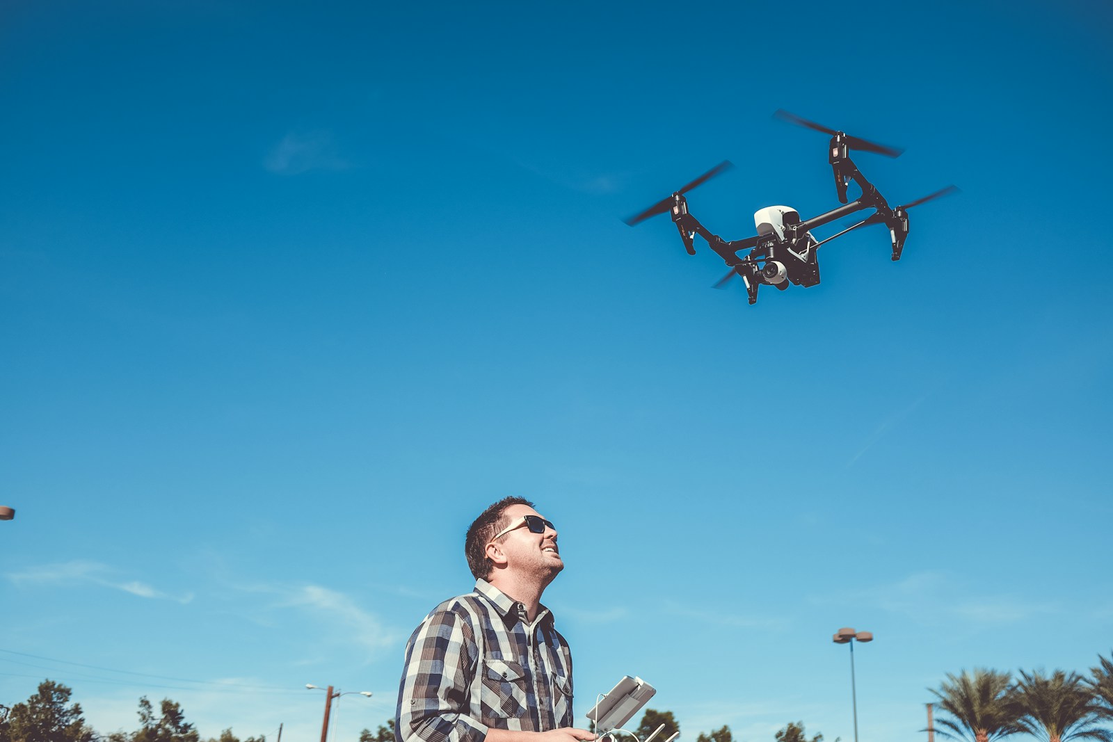 Photo by Kenny Eliason man flying drone
